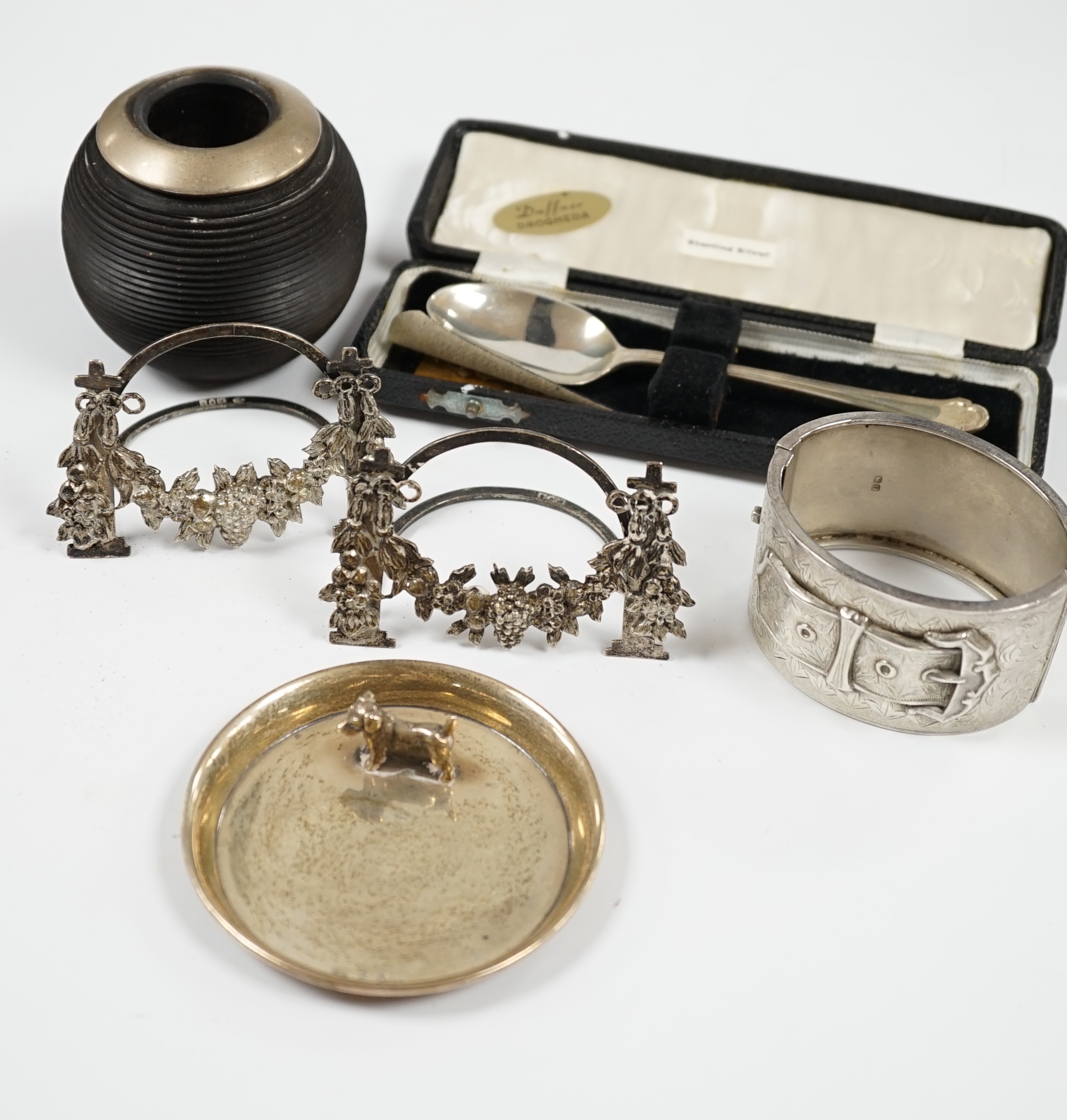 Sundry small silver including a modern mounted wooden match tidy, a George V bracelet, pair of menu holders and cased spoon. Condition - fair